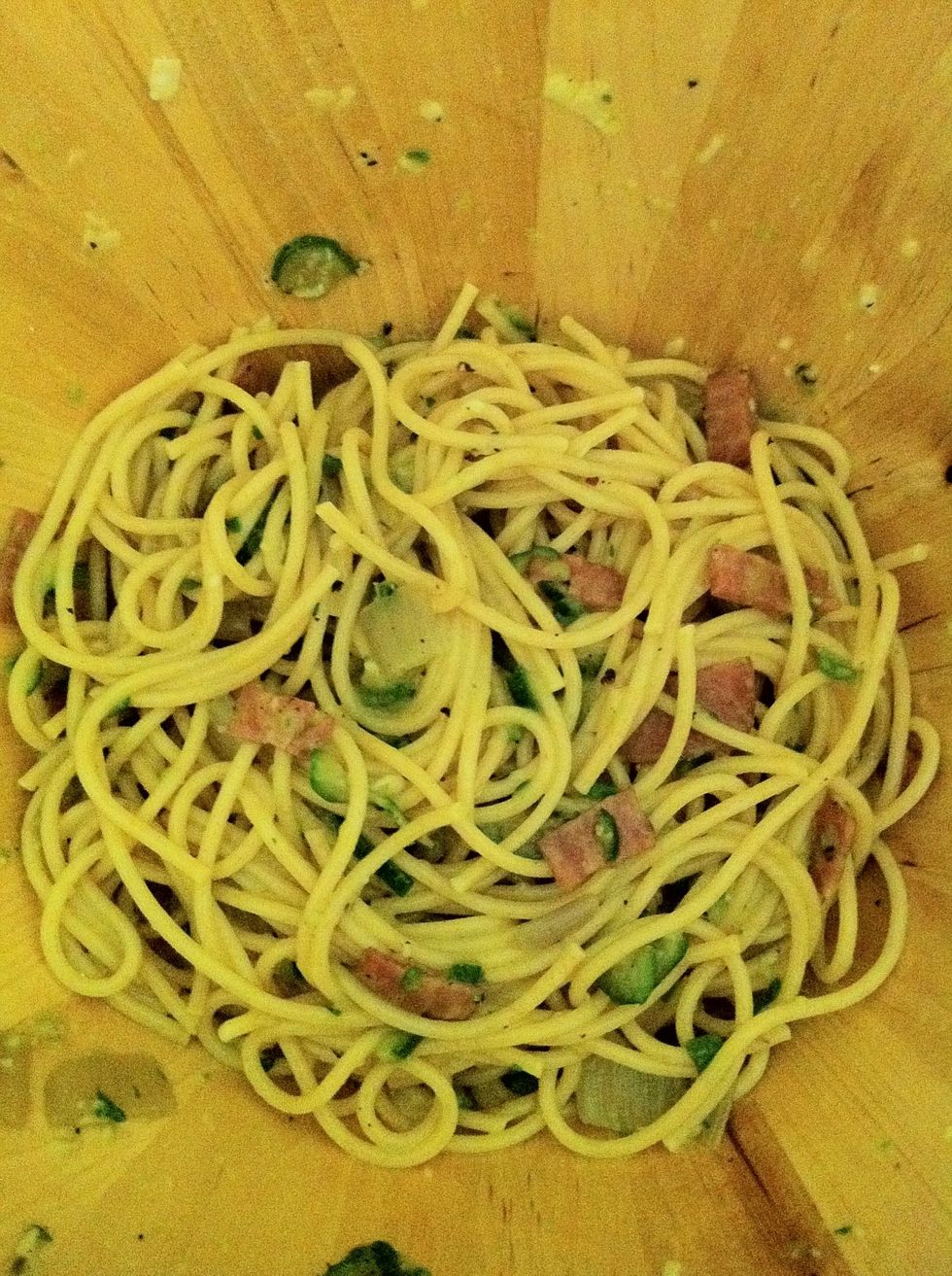 In a large bowl, toss the spaghetti with the scrambled eggs and the rest of the sauce.