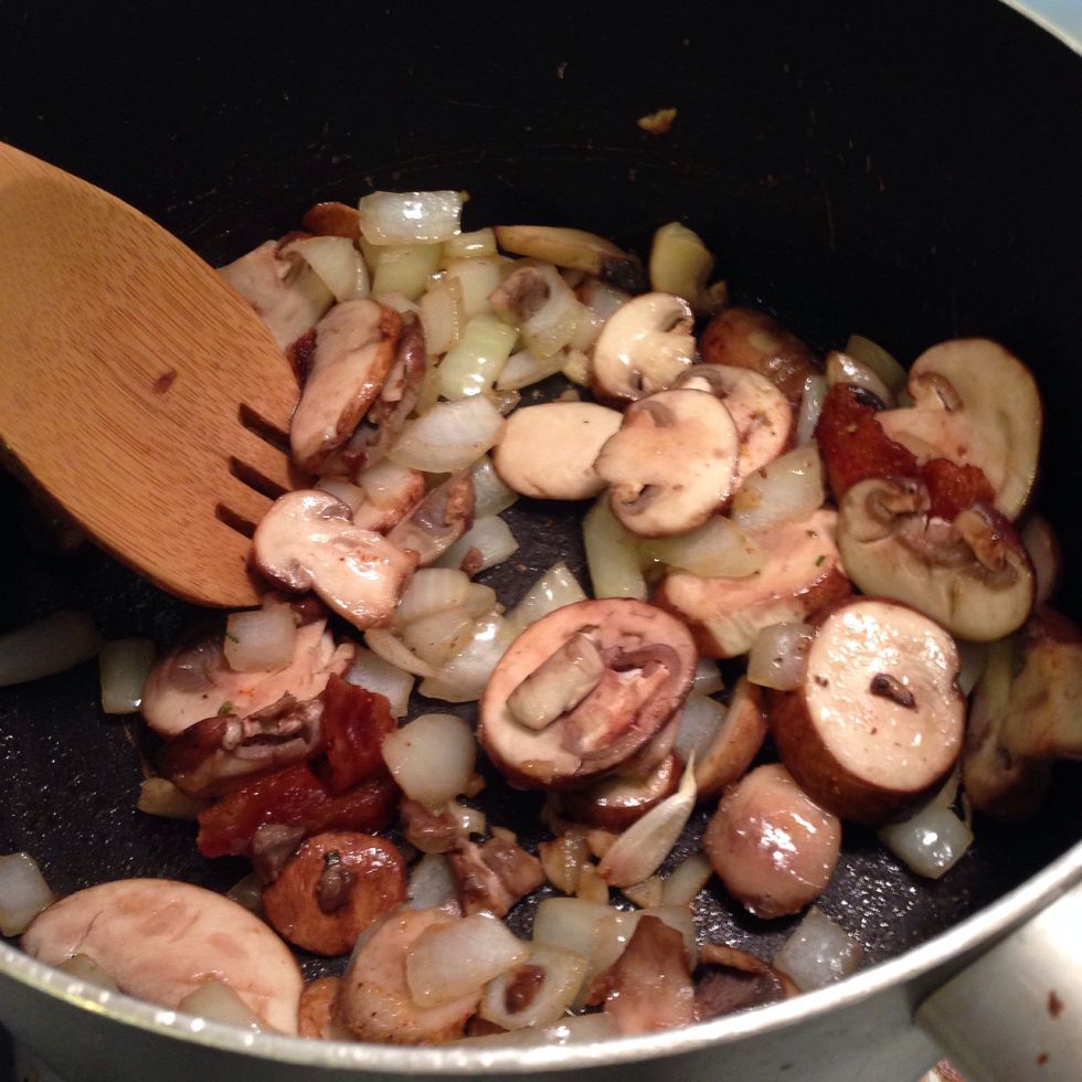 In a large deep skillet (stove top Dutch ovens work as well) heat coconut oil on medium high heat until hot - add diced onions and sliced mushrooms.