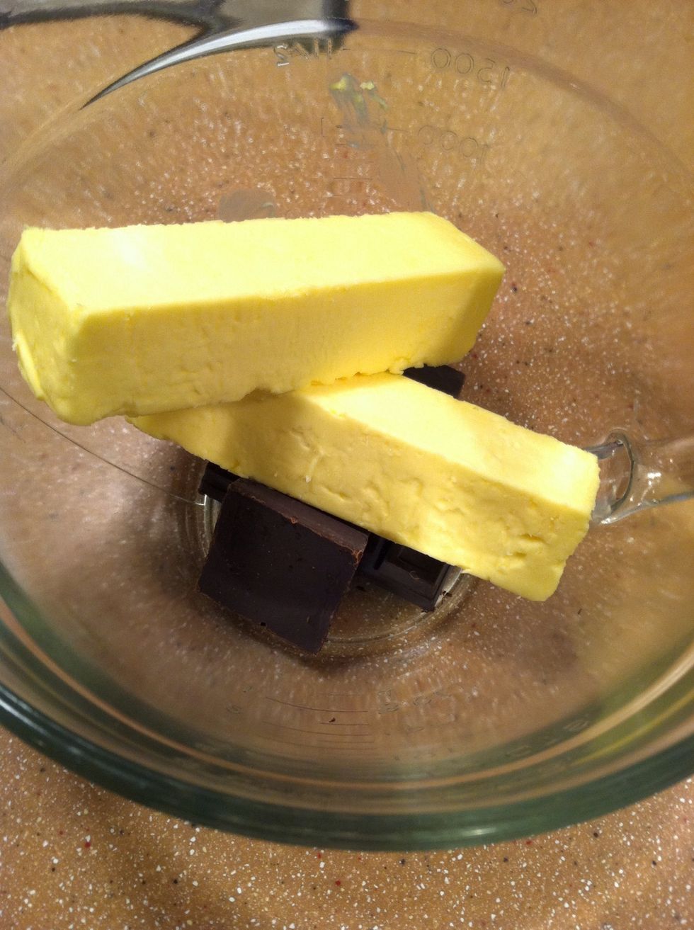 In a large measuring cup, add the 4 chocolate squares and 2 sticks of butter