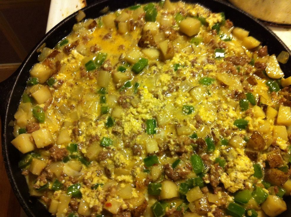 In a large mixing bowl add the eggs and 1/4 cup milk and beat well. Next add it to the skillet and stir it gently to make sure that it is mixed throughout but don\u2019t go too crazy.