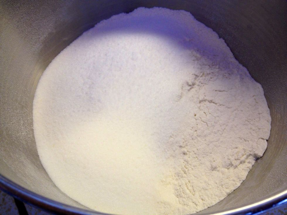 In a large mixing bowl, combine the flours, sugar and salt.