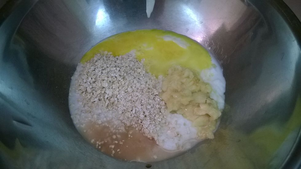 In a large mixing bowl, combine yogurt, milk, oats, vanilla extract, and beaten egg; set aside 5 minutes for oats to soften and then stir in mashed banana