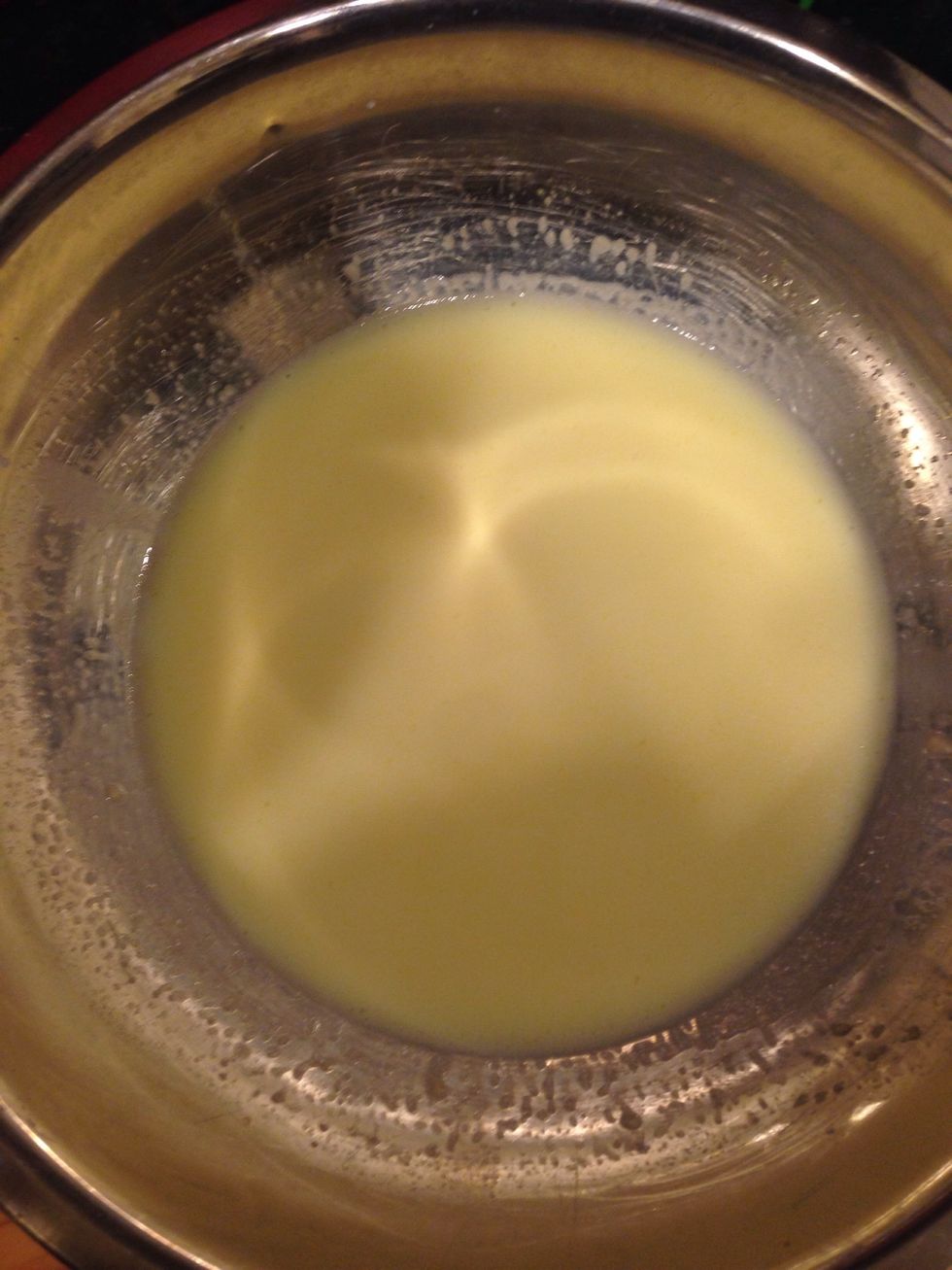 In a large mixing bowl, dissolve the yeast in the milk mixture.