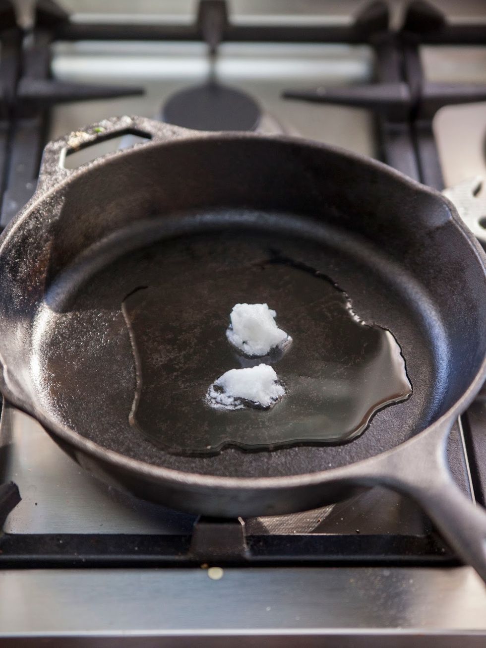 In a large pan or kadhai, heat the coconut or vegetable oil.
