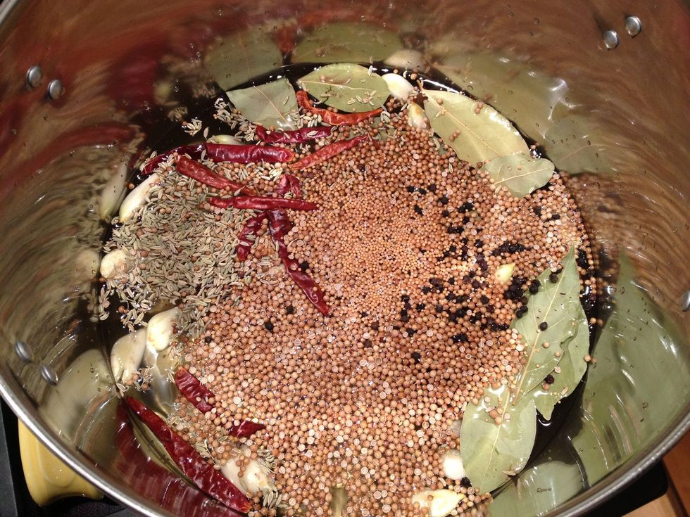 In a large pot combine the water, both vinegars, sugar, kosher salt, bay leaves, garlic cloves, chiles de \u00e1rbol, fennel seeds, coriander seeds, peppercorns and yellow mustard seeds. Bring to a boil.