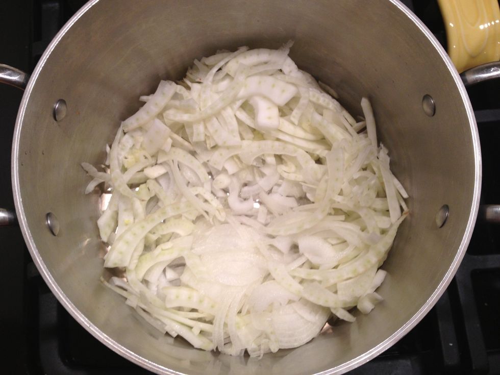 In a large pot heat the olive oil over medium high heat. Add the onion and fennel and cook, until fragrant and fennel is softened.