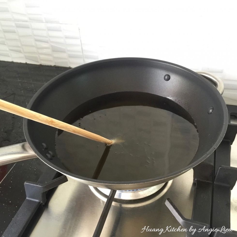 In a large pot or pan, fill with about 2 inch of vegetable oil. Heat until hot and bubbles appear at the tip when a wooden chopstick is dipped into the oil.