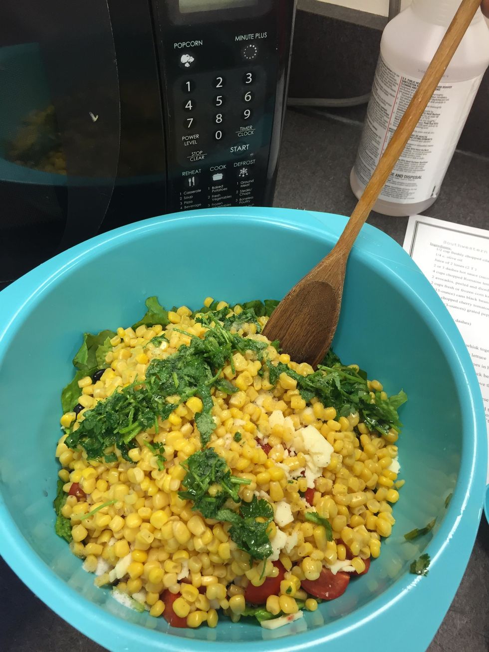 In a large serving bowl, add the lettuce, corn, beans, tomatoes, avocado, and cheese. Add the dressing, salt, and pepper and toss well.
