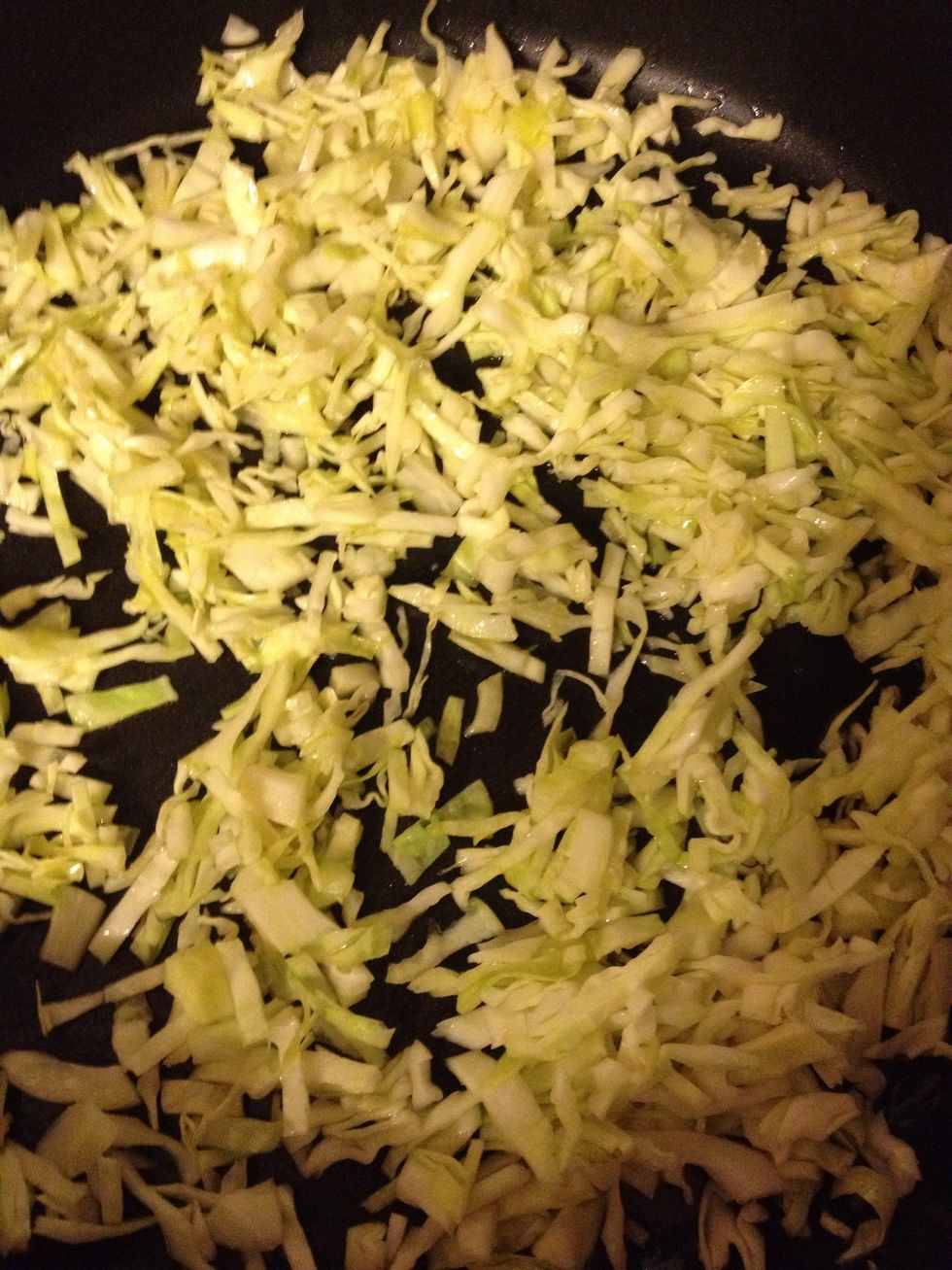 In a large skillet place oil & cabbage. Heat, covered, on low-medium heat until it begins to wilt.