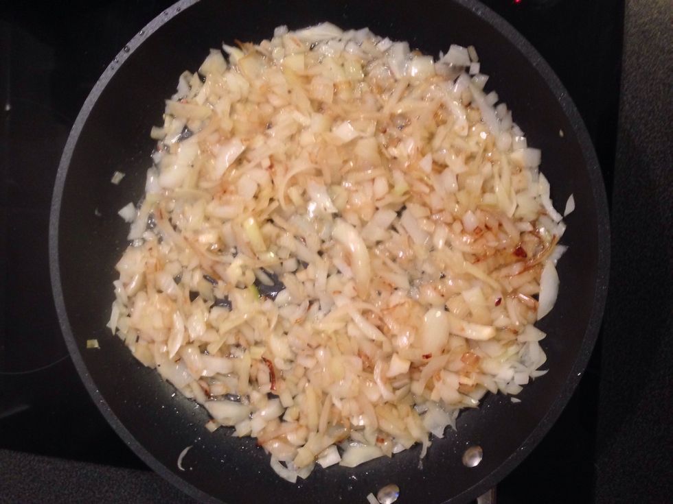 In a larger frying pan heat some olive oil and slowly melt the chopped onions.  Once melted add the baked chicken and let it all cook for a few minutes while stirring the whole every now and then