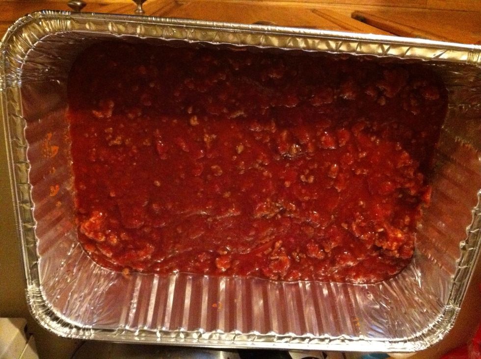 In a lasagna pan or a deep casserole dish, ladle enough sauce to cover the bottom of the pan.
