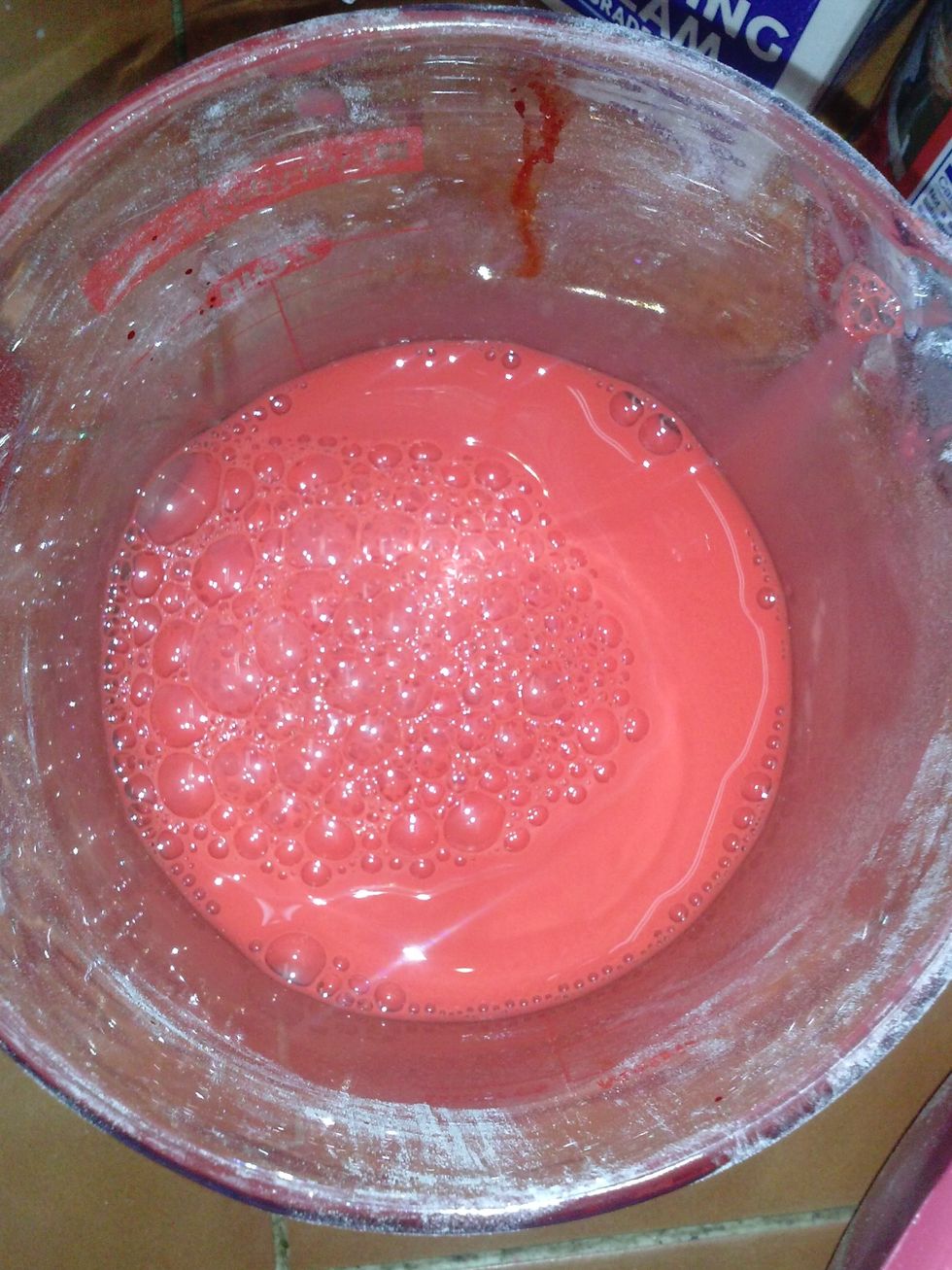In a measuring cup whisk the milk with the red food coloring.