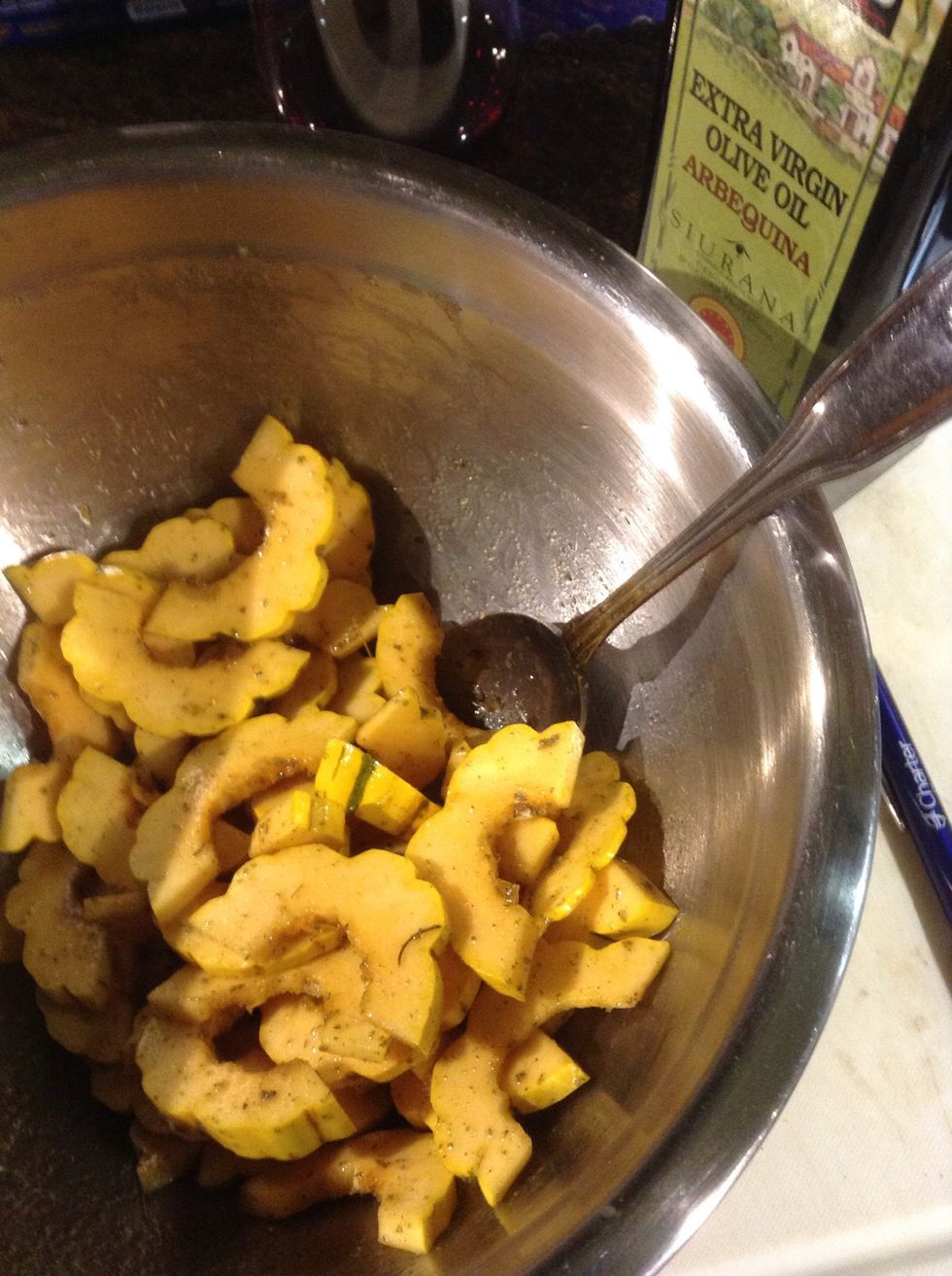In a medium mixing bowl toss the squash slices in 2 tbls olive oil and 1 tbls fresh ground sage