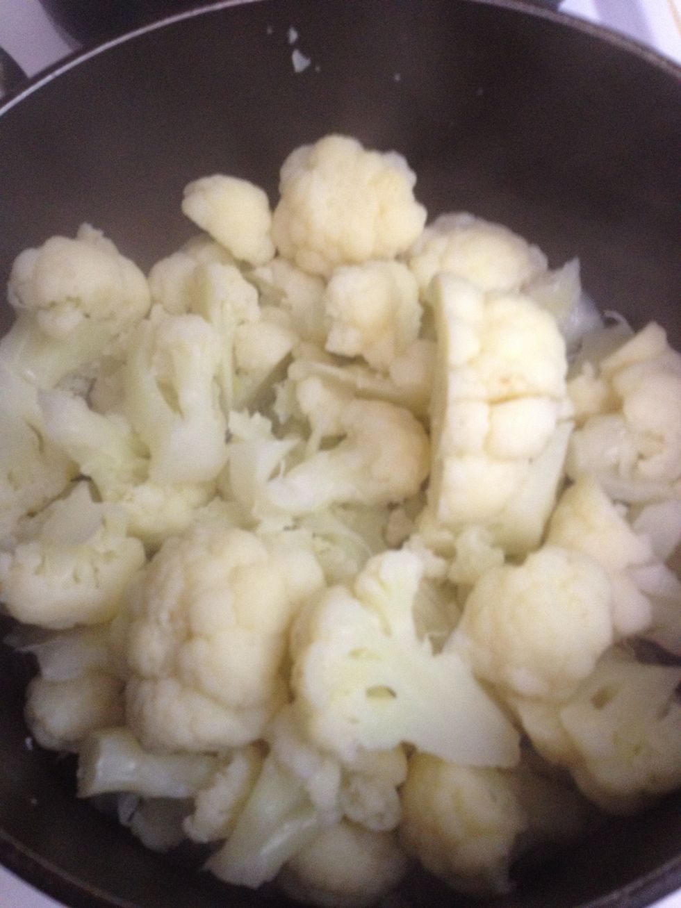 In a medium pot bring 1 cup of water to a boil and add the head of cauliflower florets to be steamed for 10 minutes.