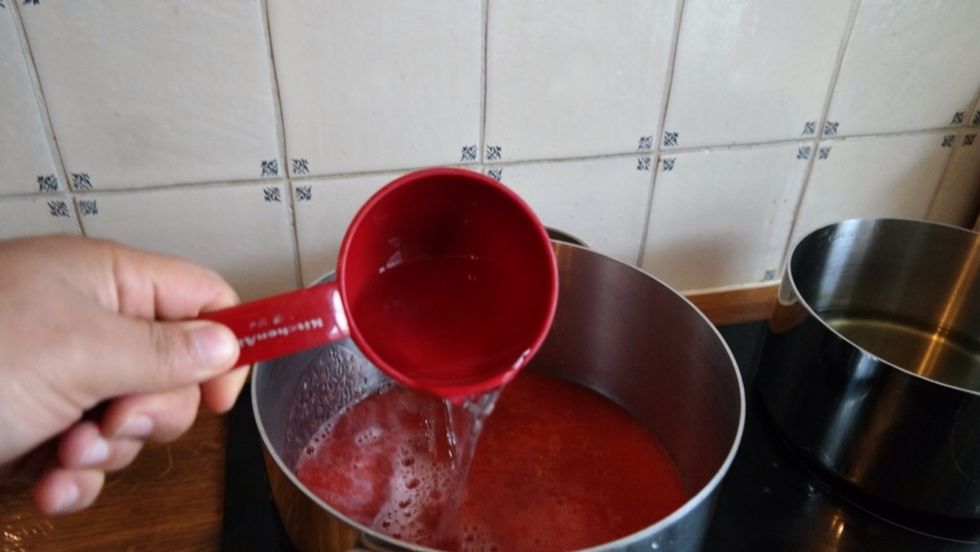 In a medium saucepan boil lemon zest from 2 lemons, 3 cups of water and the strawberry pur\u00e9e. Heat on medium and simmer for 15 minutes. Make sure that the color of the pur\u00e9e turns into pink.