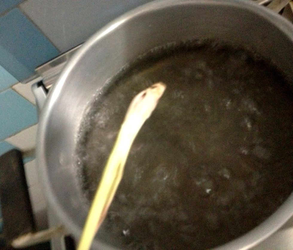 In a medium saucepan, boil some water and 1 stalk of crushed lemongrass