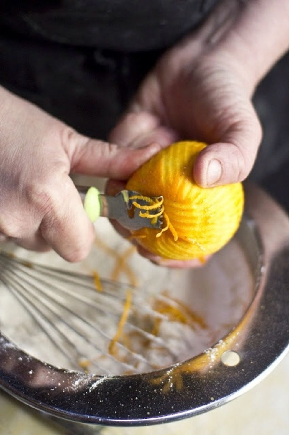 In a medium sized bowl add in the flours, sugar, baking powder, nutmeg, salt, and orange zest.  Mix it all  together with a whisk
