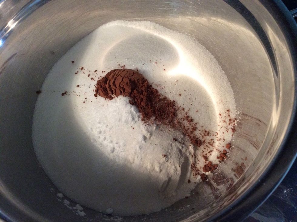 In a mixing bowl pour the flour, sugar, baking soda, salt, and cocoa powder. Stir with a spoon until combined.