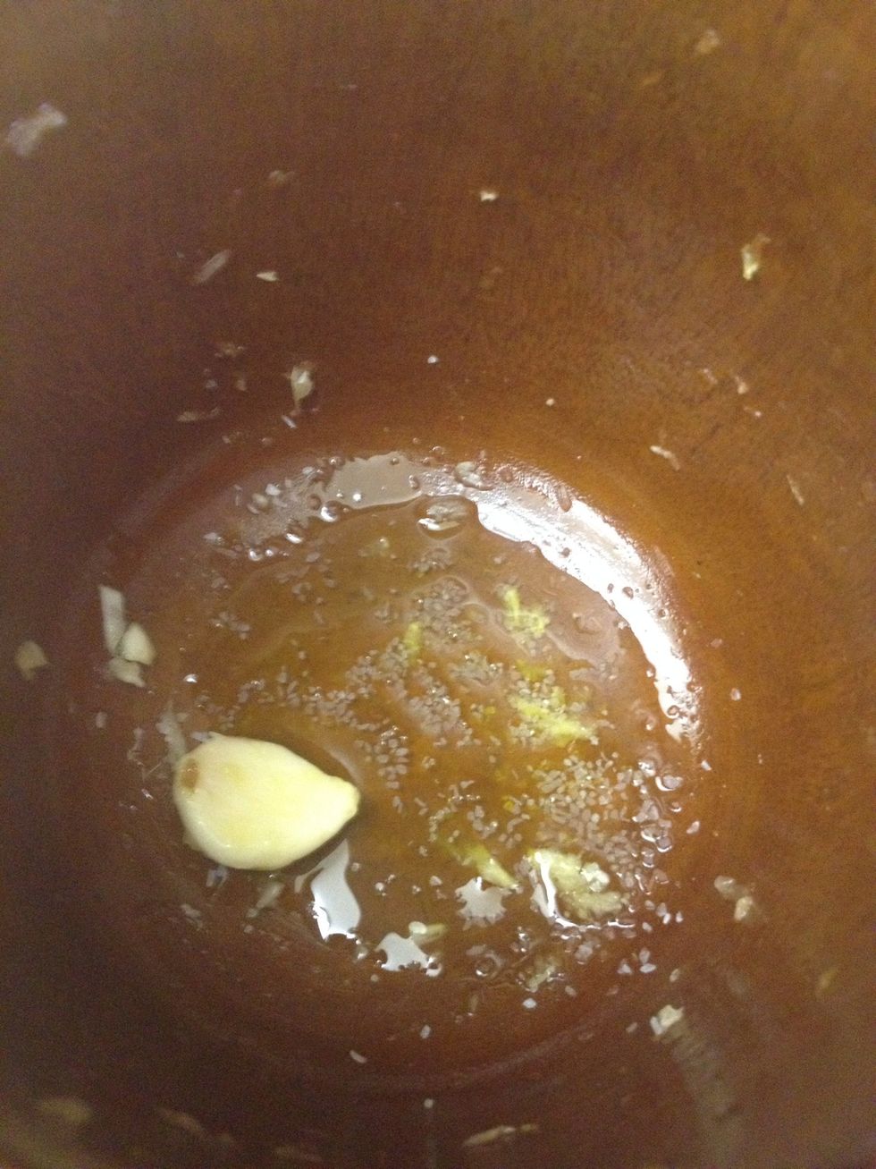 In a mortar and pestle, add olive oil, garlic cloves and a few pinches of salt. (Clearly this recipe needs to be adjusted if you don't care for garlic.)