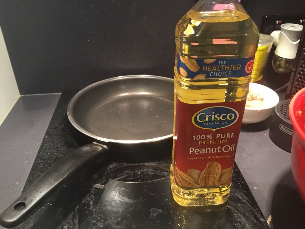 In a pan add peanut oil to cover the whole pan.