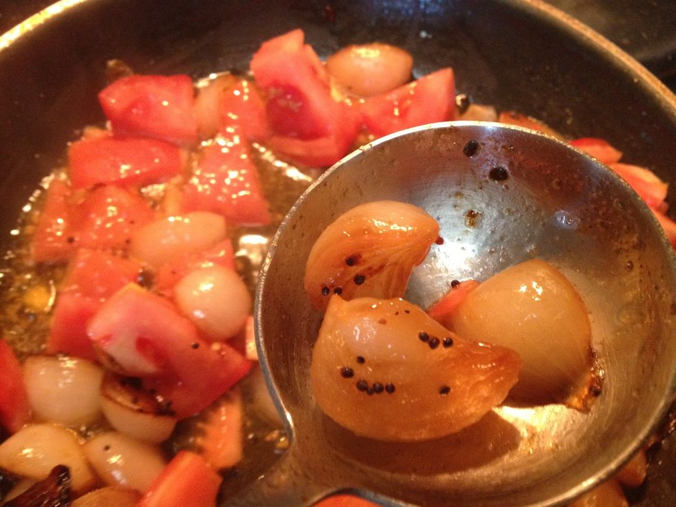 In a pan add vegetable oil once it heats up add asafoetida cook for 20 secs. Add mustard seeds let them splutter add shallots once they start getting brown add tomatoes and cook for 5-7 mins till done