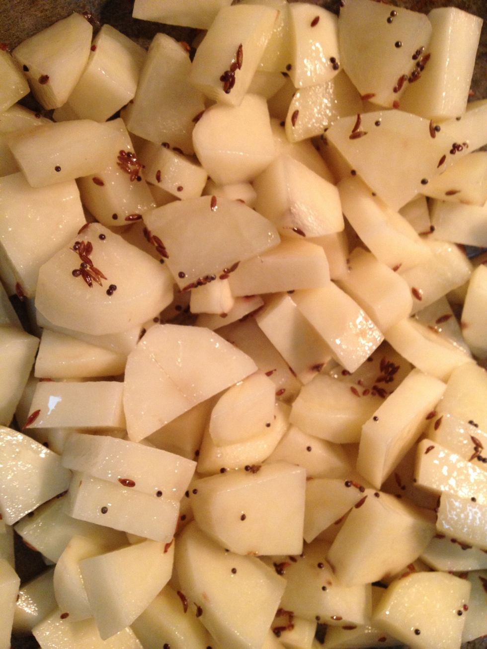In a pan heat oil add mustard seeds and let them splutter once they start spluttering add cumin seeds and then add potatoes mix them well and cover with a lid and cook on medium heat for 3 mins .