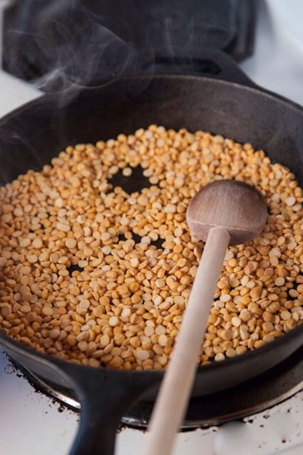 In a pan or skillet dry roast the chana dal until it turns a golden brown.