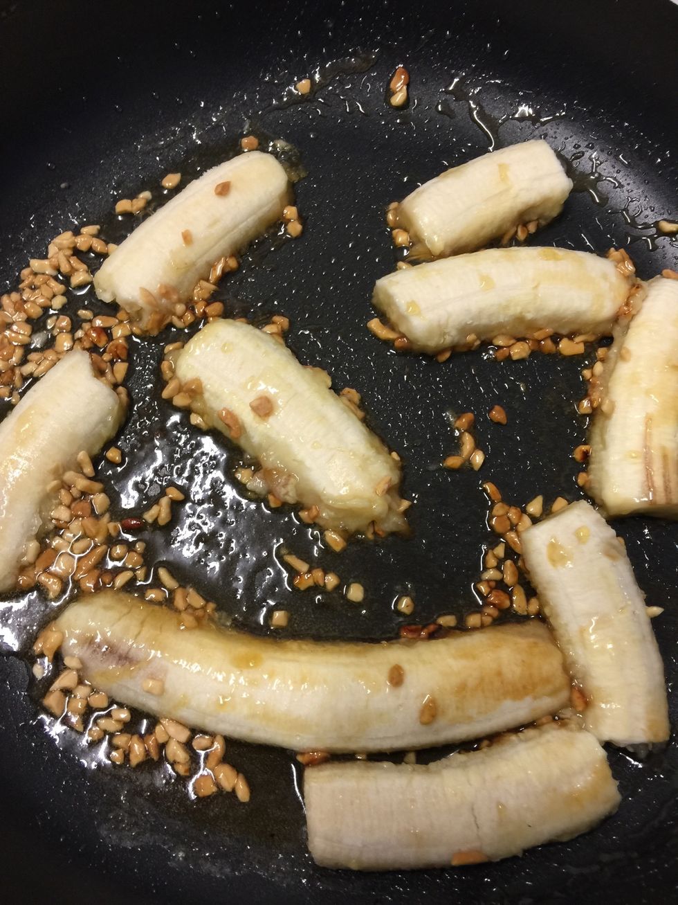 In a pan place brown sugar, butter, crushed peanuts and bananas and let simmer on a med-low heat