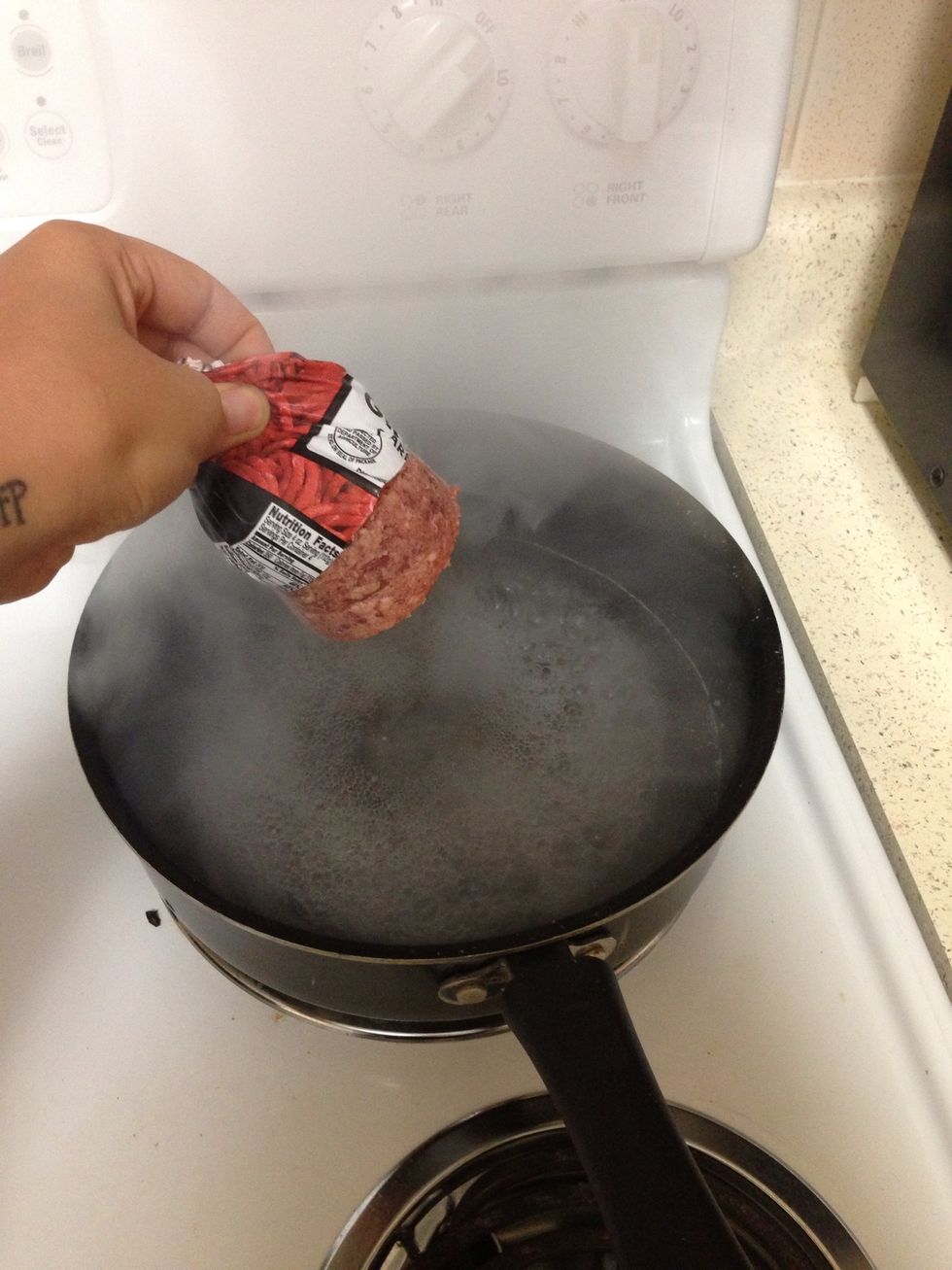 In a pan put about 1/4 cup of water and cook the ground beef, it will take less than a minute, if there is any water left after is cooked just drain it