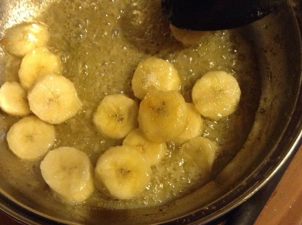 In a pan, put the banana sliced, with butter and sugar,cinamon, wait untill get golden...... Add some Orange liquor and feel the smell.....