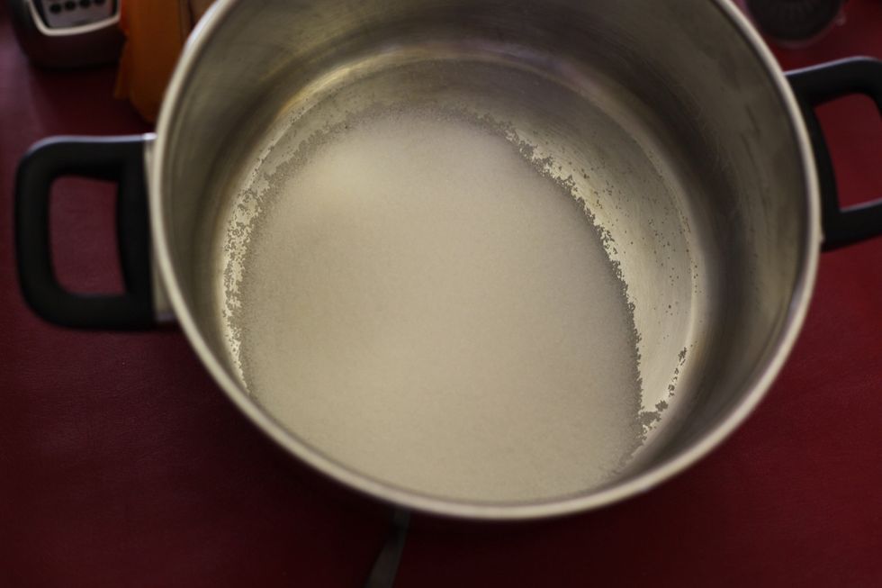 In a pot add 1 cup of sugar and please don't start the fire yet until you've added the eggs.