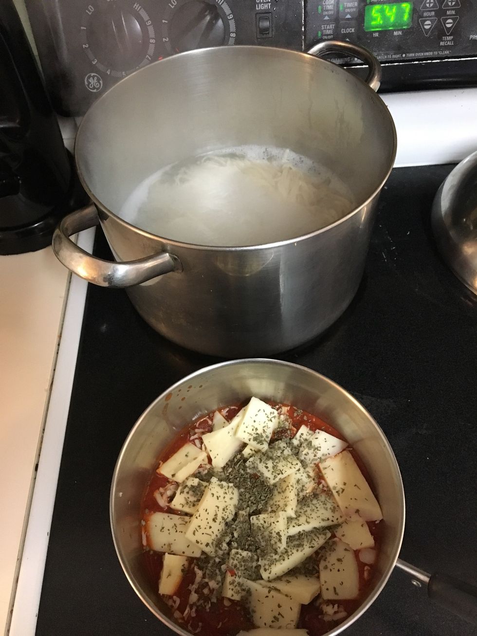 In a pot boil noodles till soft. In separate pot mix pasta sauce,basil leaves, cayenne pepper, and cheese. Melt at Love ten and let simmer on low. ( stir every few minutes)