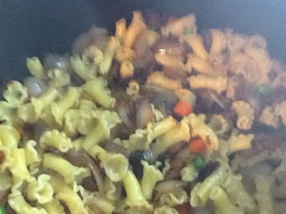 In a pot combine the pasta, onions and peas and carrots; then stir.