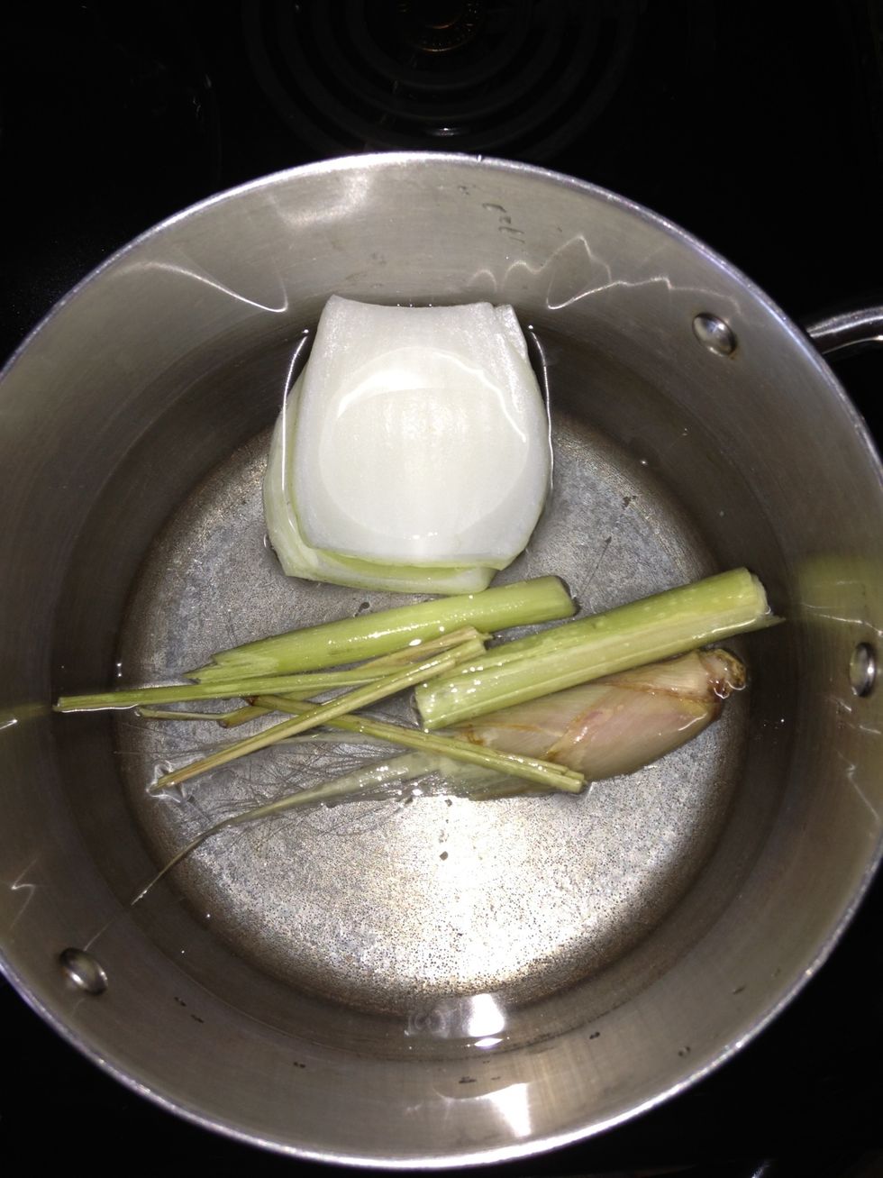 In a pot of water add onion, lemongrass, salt, and sugar. Then let boil. Put in a piece of eye round beef. Afterwards place on low and leave for around 1/2 hour or until the meat is cooked