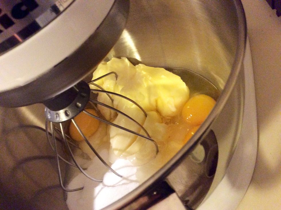 In a powered blender mix the eggs, sugar, and lightly melted butter together.
