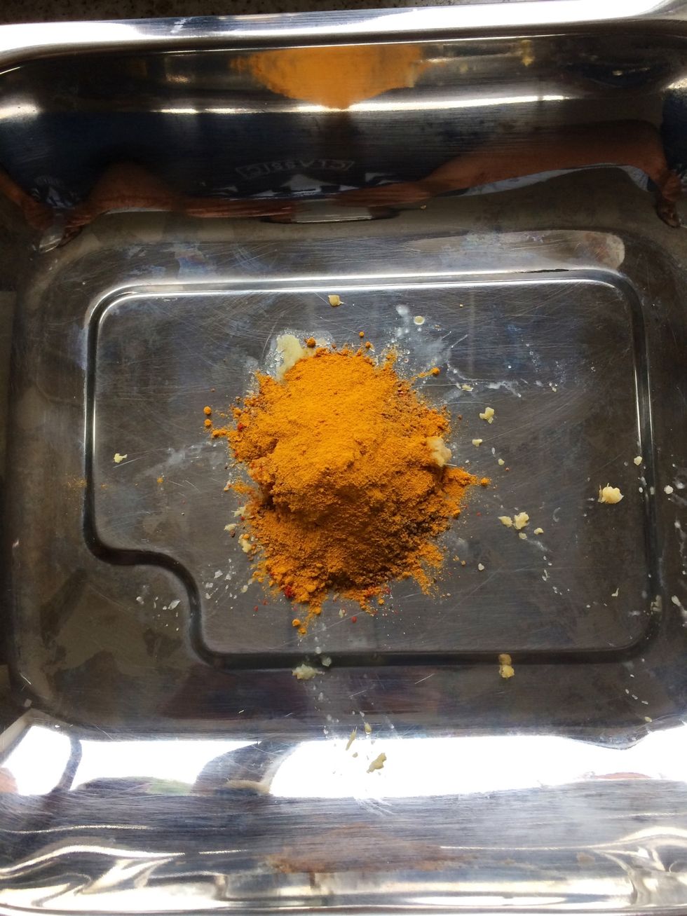 In a roasting tray put all the spices, ginger and garlic. This is a medium to hot taste so reduce the amount of chilli powder if it's too spicy.