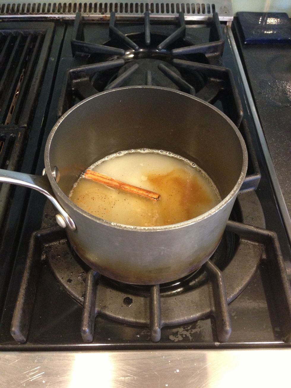 In a saucepan, bring 1/2 cup water, 1/2 cup sugar, 2 tsps lemon juice, 1 cinnamon stick, a pinch of nutmeg, and 1 tsp vanilla extract to a boil. Reduce heat to medium.