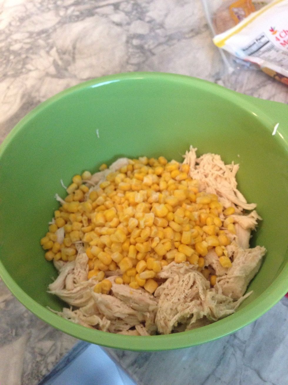 In a separate bowl add half the bag of frozen corn, with the shredded chicken, salt and pepper.