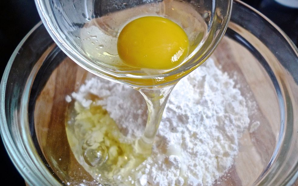 In a separate bowl, add in flour, vegetable oil, cornstarch, salt, pepper and lastly an egg.