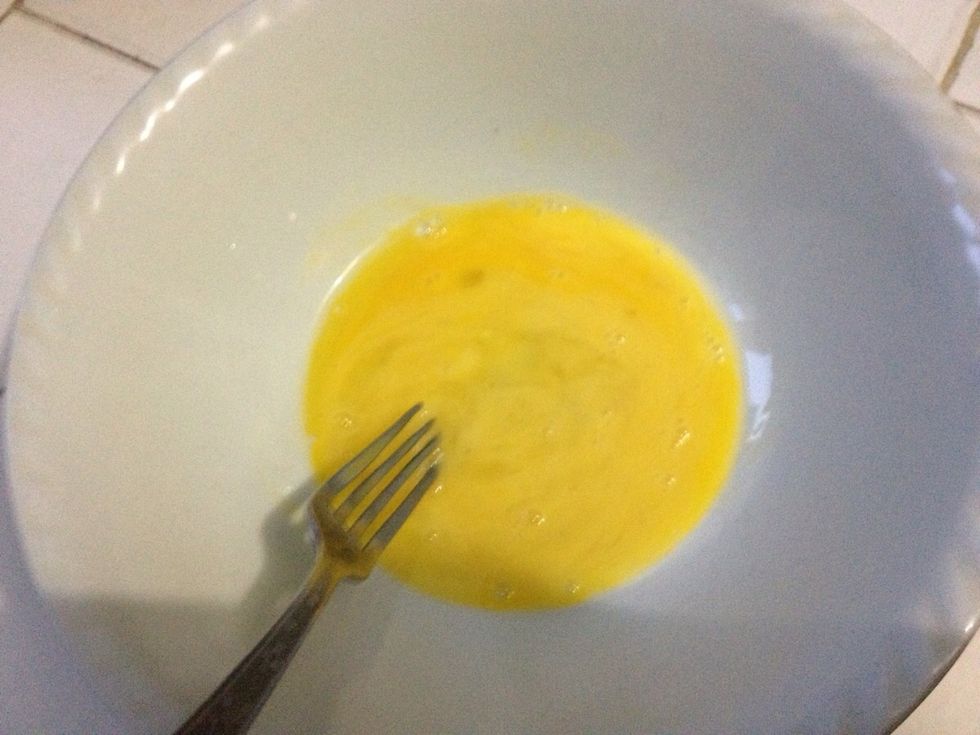 In a separate bowl, beat 1 egg