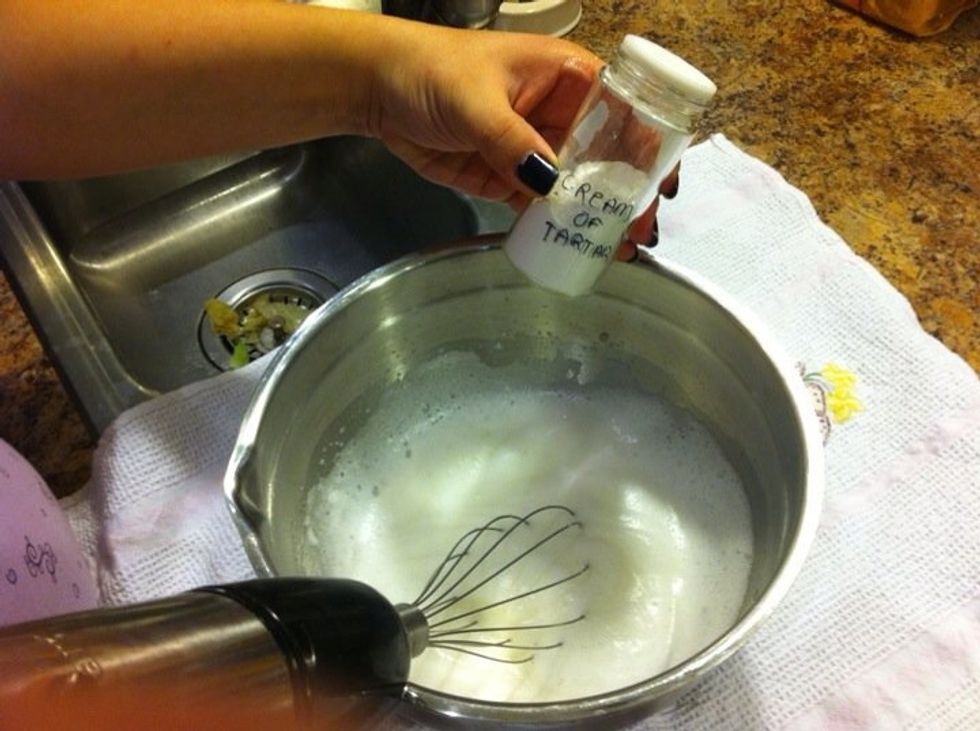 In a separate bowl, beat egg whites. Add cream of tartar to stabilize the whites.