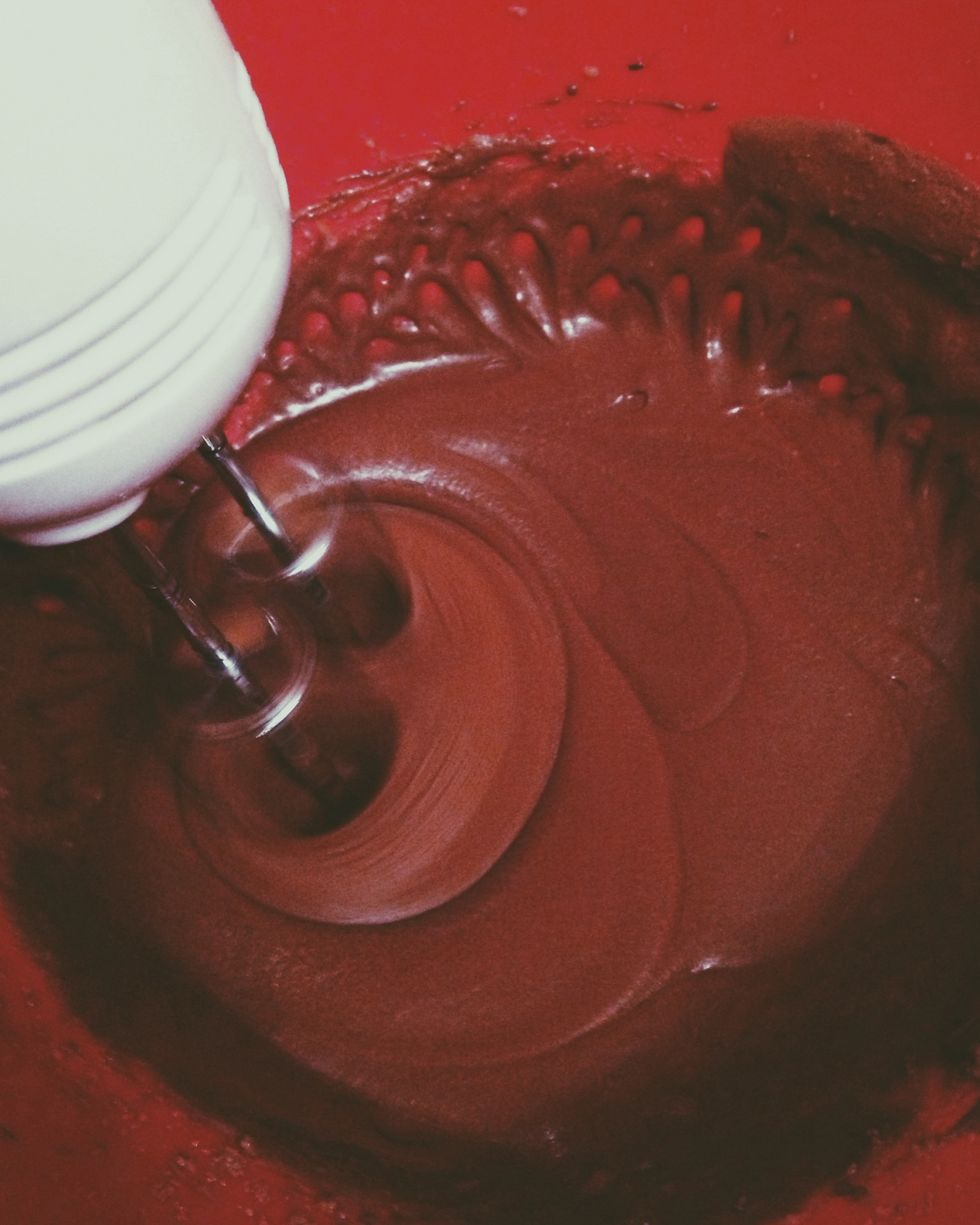 In a separate bowl, beat the butter then add water, brown sugar and eggs. Once the batter is smooth, mix in the molasses. Then slowly add half of the dry mixture.