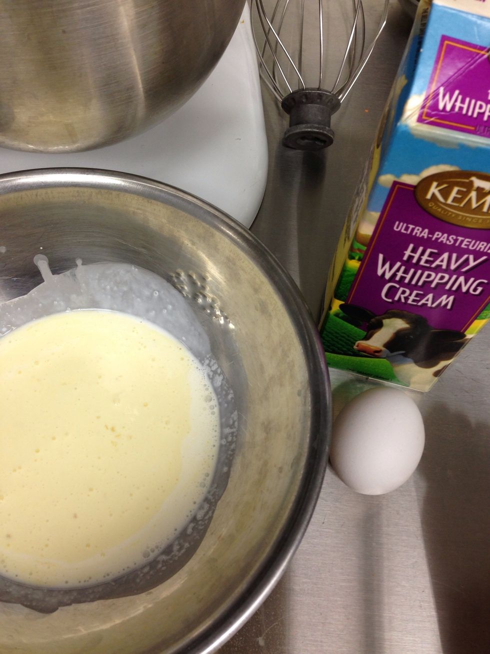 In a separate bowl, combine 1 egg and heavy cream.