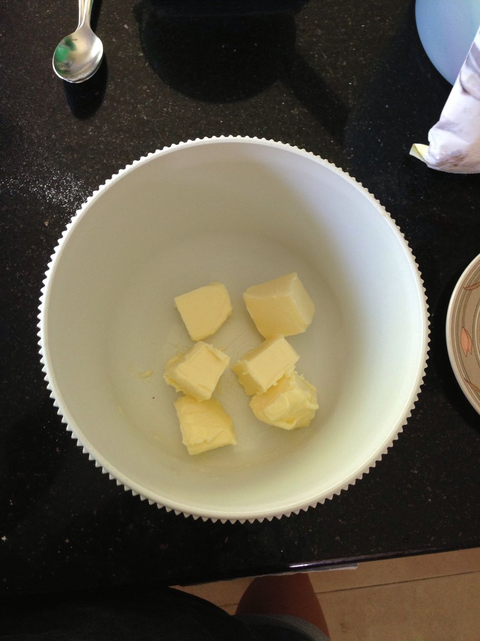 In a separate bowl, cut your salted, softened butter into cubes like so. Beat on medium speed (abt 3 mins) until creamy and pale!