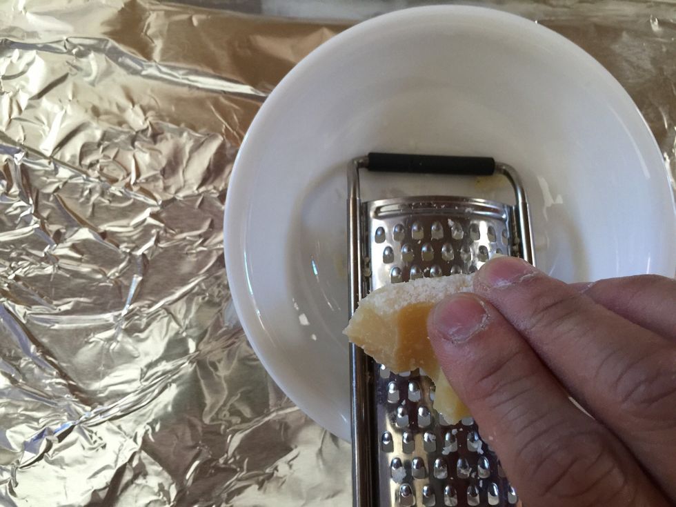 In a separate bowl, grate Parmesan cheese. Set aside.