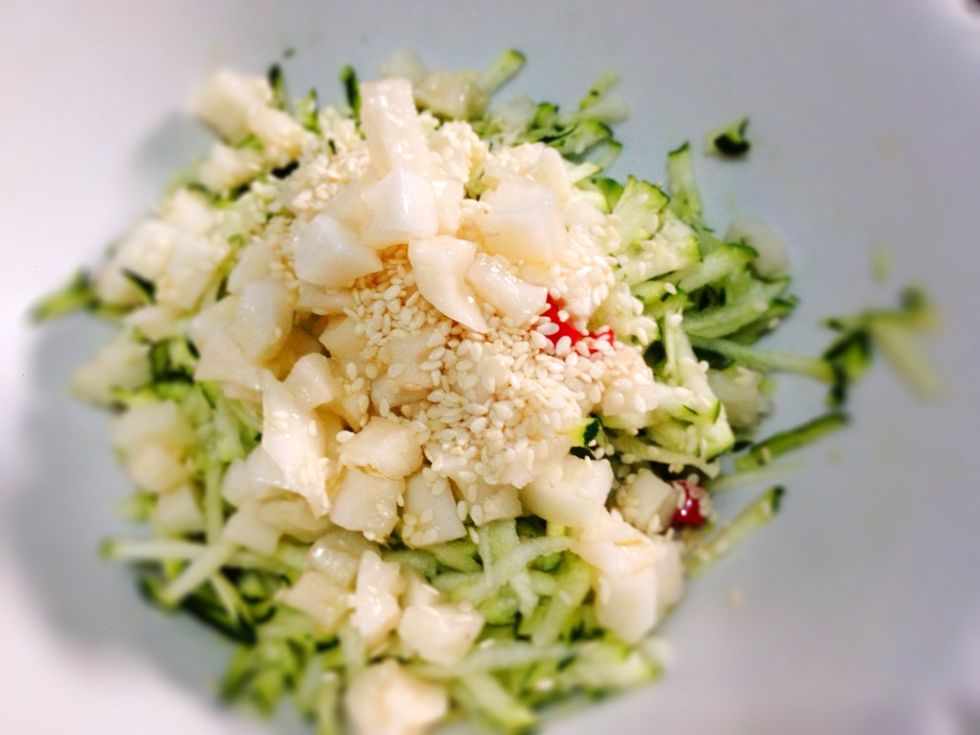 In a separate bowl, toss together the grated zucchini, sesame seeds an pickled daikon. Add in half pickling liquid or more if you like. Note: I'm only add in the red cabbage few mnts before serving