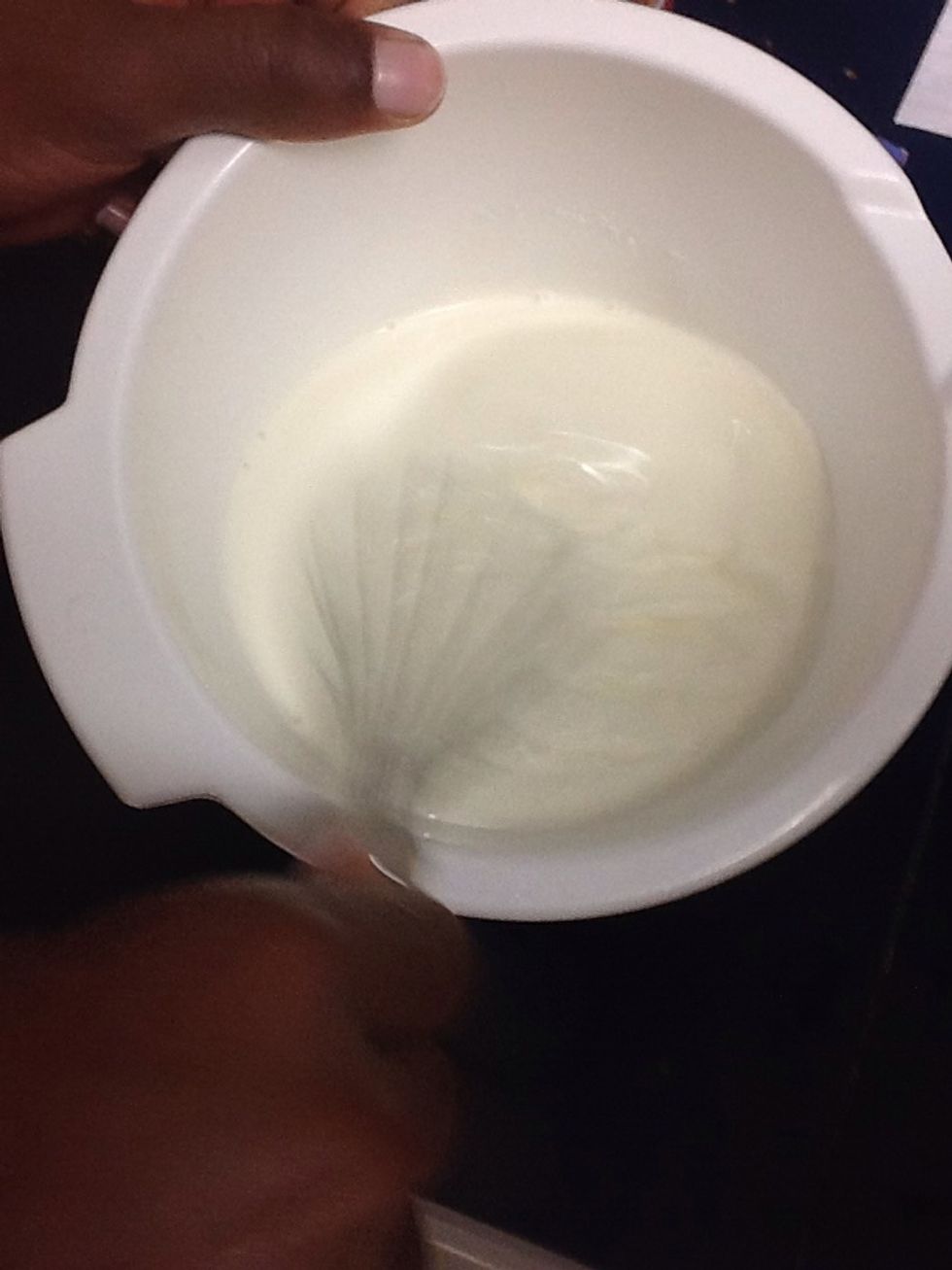 In a separate bowl, whip the cream until stiff peaks form using whisk.