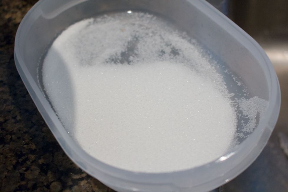 In a separate container/tray put some sugar in.