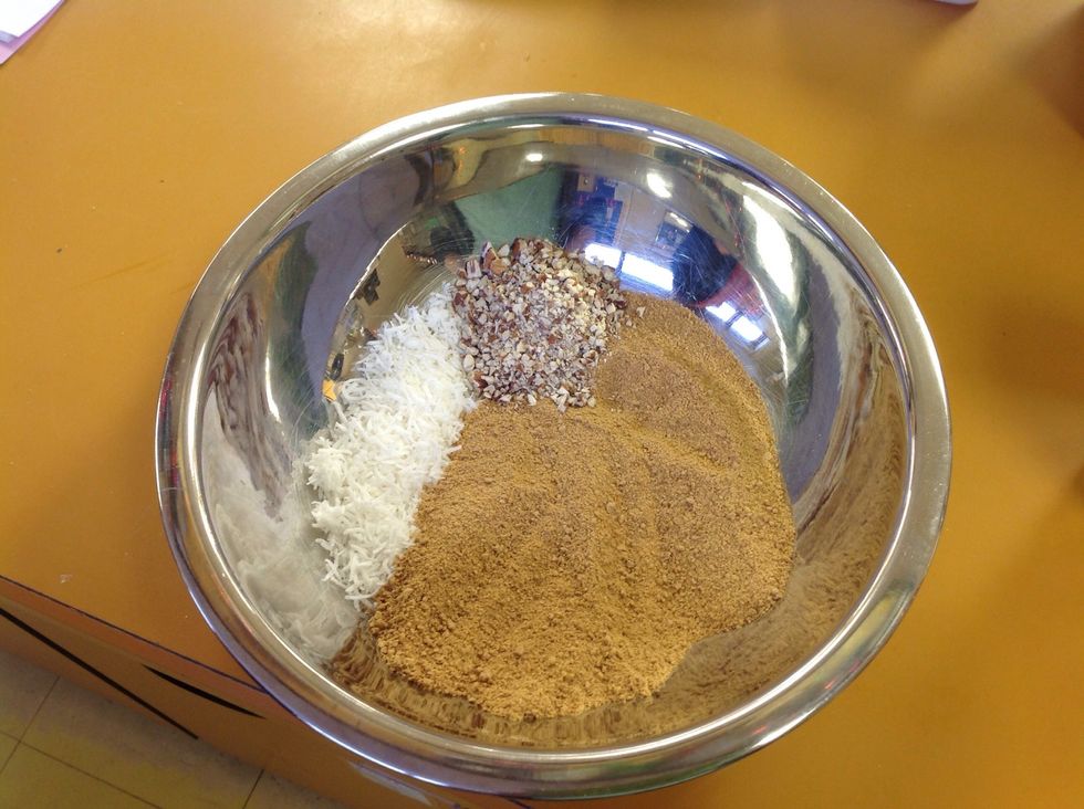 In a separate larger bowl add the graham cracker, coconut and nuts. If you are making peanut butter bars, add in peanuts.