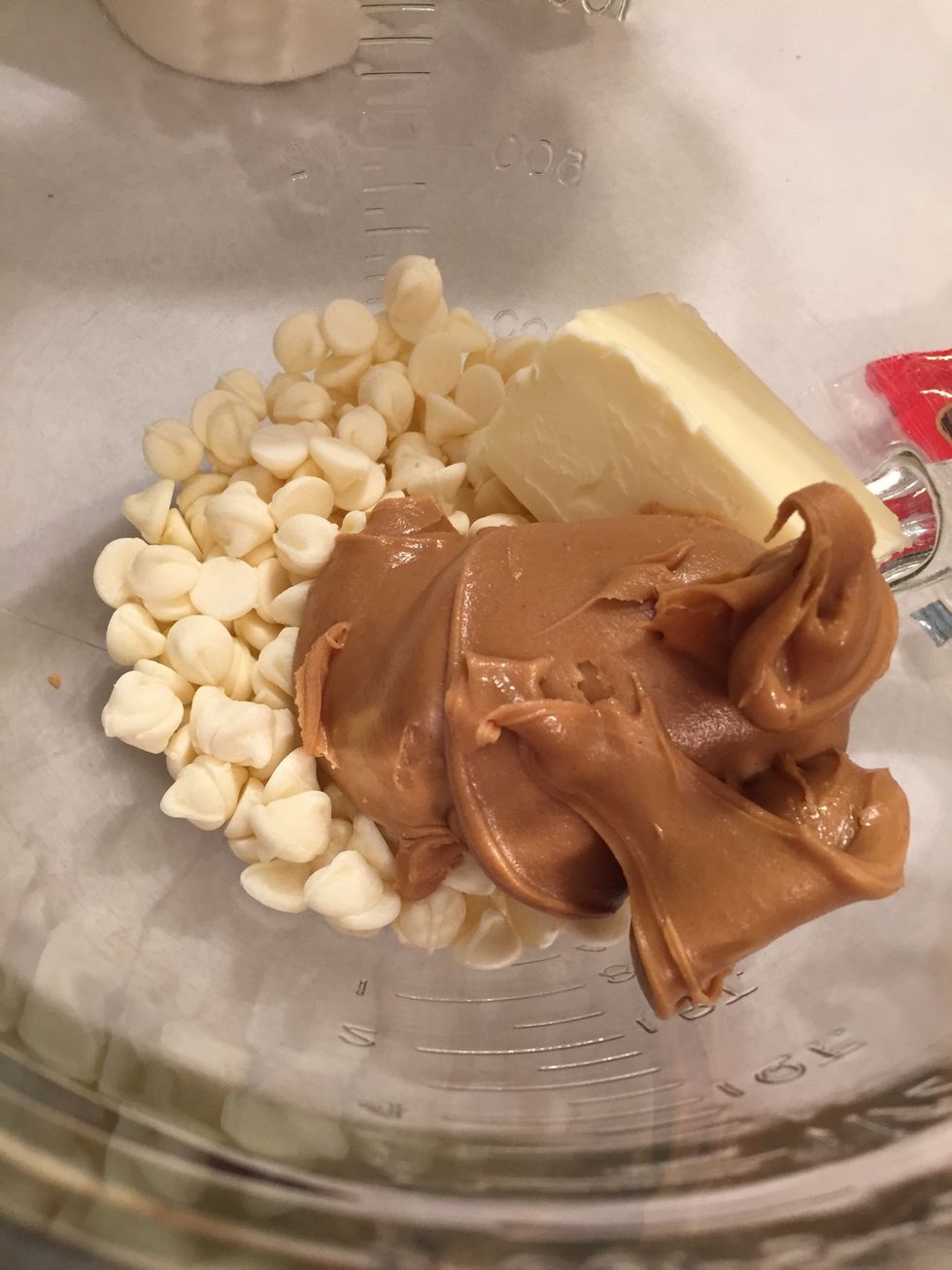 In a separate microwavable-safe bowl, put a cup of white chocolate morsels, a 1/2 cup of peanut butter, and a 1/4 cup of butter in the bowl. Then microwave for one minute and stir.